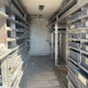 2012 Isuzu NPR box truck with shelves and bins.